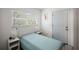 Bright bedroom featuring a comfortable bed, natural light from a large window, and calming decor at 18526 Sweetbay Ln, Dade City, FL 33523