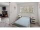 Well-lit bedroom boasts a large window and is connected to a cozy living room space at 18526 Sweetbay Ln, Dade City, FL 33523