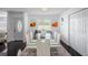 Dining area features a glass-top table, white chairs, and modern décor at 18526 Sweetbay Ln, Dade City, FL 33523