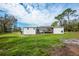 The back of the home showing the screened-in patio and nice landscaping at 18526 Sweetbay Ln, Dade City, FL 33523