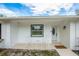 Cozy front porch with rocking chairs and a charming front door at 18526 Sweetbay Ln, Dade City, FL 33523