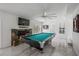 A game room featuring a pool table, fireplace and TV, ideal for entertaining at 18526 Sweetbay Ln, Dade City, FL 33523