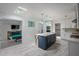 Bright kitchen with large island, skylights, pendant lights and an adjacent recreation room at 18526 Sweetbay Ln, Dade City, FL 33523