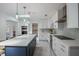 Modern kitchen with white cabinets, stainless steel appliances, and a large central island at 18526 Sweetbay Ln, Dade City, FL 33523