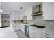 Bright kitchen features white cabinetry, stainless steel appliances, and a tile backsplash at 18526 Sweetbay Ln, Dade City, FL 33523