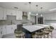 Updated kitchen with stainless steel appliances, large island, and modern lighting fixtures at 18526 Sweetbay Ln, Dade City, FL 33523