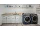 Laundry room features modern appliances, sleek countertops, and ample storage solutions at 18526 Sweetbay Ln, Dade City, FL 33523