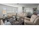 Spacious living room with dark wood floors leading into the dining area at 18526 Sweetbay Ln, Dade City, FL 33523