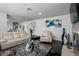 Open living area with ample seating, dark wood floors, and tasteful decor at 18526 Sweetbay Ln, Dade City, FL 33523