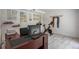 Bright office space with desk, exercise bike, marble floors, and wall-mounted degrees or licenses at 18526 Sweetbay Ln, Dade City, FL 33523