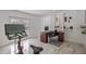 Open office featuring a desk, exercise bike, and patio doors leading to a pool area at 18526 Sweetbay Ln, Dade City, FL 33523