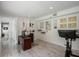 Spacious office area with a desk, exercise bike and diplomas on the wall, accentuated by marble floors at 18526 Sweetbay Ln, Dade City, FL 33523