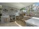 Outdoor kitchen features stainless steel appliances, stylish backsplash, and convenient access to the yard at 18526 Sweetbay Ln, Dade City, FL 33523