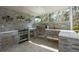Beautiful outdoor kitchen with stainless steel appliances, sleek countertops, and decorative shelving at 18526 Sweetbay Ln, Dade City, FL 33523