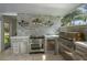 Modern outdoor kitchen equipped with stainless steel appliances and stylish tiled walls at 18526 Sweetbay Ln, Dade City, FL 33523