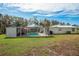 The screened-in pool has seating for residents and guests to enjoy at 18526 Sweetbay Ln, Dade City, FL 33523