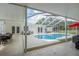 Inviting pool features an enclosed patio with lounge seating, and a dining set for outdoor enjoyment at 18526 Sweetbay Ln, Dade City, FL 33523