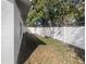 Spacious backyard featuring a well-maintained lawn and a white fence at 2052 Sheffield Ct, Oldsmar, FL 34677
