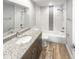 Renovated bathroom featuring modern fixtures, subway tile and a granite-topped vanity at 2052 Sheffield Ct, Oldsmar, FL 34677
