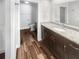 Bright bathroom featuring granite countertops, hardwood floors, and a modern toilet at 2052 Sheffield Ct, Oldsmar, FL 34677