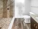 Elegant bathroom showcasing a tiled shower with stone accents and a granite-topped vanity at 2052 Sheffield Ct, Oldsmar, FL 34677