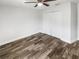 Bright bedroom featuring hardwood floors, a ceiling fan, and a double door closet at 2052 Sheffield Ct, Oldsmar, FL 34677