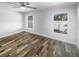 Bright, empty bedroom with new flooring, a ceiling fan, and plenty of natural light from the windows at 2052 Sheffield Ct, Oldsmar, FL 34677