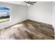 Bedroom featuring hardwood floors, a ceiling fan, and a bright window at 2052 Sheffield Ct, Oldsmar, FL 34677