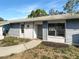Charming single-story home with a well-maintained yard, textured facade and modern windows at 2052 Sheffield Ct, Oldsmar, FL 34677