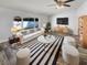 Bright living room featuring a black and white rug, modern furniture, and a large window for natural light at 2052 Sheffield Ct, Oldsmar, FL 34677