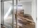 Covered patio featuring wood-look floor tiles with a sliding glass door leading to a bright interior space at 2052 Sheffield Ct, Oldsmar, FL 34677