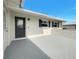 Inviting front porch with a stylish front door and modern accents at 507 Chevy Chase Dr, Sarasota, FL 34243