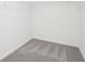 Walk-in closet featuring gray carpeting, wire shelving, and white walls at 6151 Calle Ochoa St, Zephyrhills, FL 33542