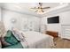 Primary bedroom with tray ceiling, fan, plantation shutters, and access to the outdoor living at 6559 Tidwell St, North Port, FL 34291