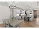 Elegant kitchen featuring white cabinets, granite countertops, and an island with pendant lights at 6559 Tidwell St, North Port, FL 34291