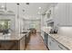 Modern kitchen featuring a large island, sleek countertops, and an adjacent dining area at 6559 Tidwell St, North Port, FL 34291