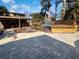 Backyard featuring a wooden deck surrounding a pool, bar, and brick pavers under sunny skies at 141 81St N Ave, St Petersburg, FL 33702