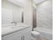 Modern bathroom featuring a double sink vanity, tiled shower, and contemporary fixtures at 24299 Kingsway Cir, Punta Gorda, FL 33983