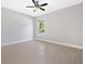 Bedroom featuring tile flooring, neutral walls, a ceiling fan, and a bright window view at 24299 Kingsway Cir, Punta Gorda, FL 33983