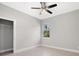 Bedroom boasts tile flooring, natural light from a window, and a closet with shelving at 24299 Kingsway Cir, Punta Gorda, FL 33983