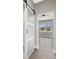 Bedroom featuring a sliding barn door and bright window with views of the neighborhood at 24299 Kingsway Cir, Punta Gorda, FL 33983