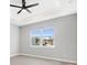 Bedroom with tray ceiling, recessed lights, ceiling fan, and large window with neighborhood views at 24299 Kingsway Cir, Punta Gorda, FL 33983