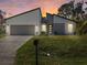 Beautiful modern home with well-manicured lawn, two car garage and stylish architectural design at 24299 Kingsway Cir, Punta Gorda, FL 33983