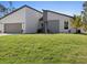 Well-manicured lawn and modern architectural design enhance the curb appeal of this home at 24299 Kingsway Cir, Punta Gorda, FL 33983