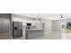 Modern kitchen with stainless steel appliances, island, and abundant natural light at 24299 Kingsway Cir, Punta Gorda, FL 33983