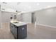 Open kitchen and living space with a large center island and modern lighting fixtures at 24299 Kingsway Cir, Punta Gorda, FL 33983