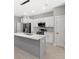 Kitchen with stainless steel appliances, a center island and modern pendant lighting at 24299 Kingsway Cir, Punta Gorda, FL 33983