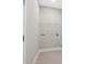 Bright laundry room features tile flooring, convenient hookups, and a wire rack for organized storage at 24299 Kingsway Cir, Punta Gorda, FL 33983