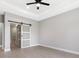 A bedroom with wood-look tile and a sliding glass barn door at 24520 Kingsway Cir, Punta Gorda, FL 33983