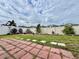 Landscaped backyard with a white fence, offering privacy and outdoor enjoyment at 724 Parker Den Dr, Ruskin, FL 33570